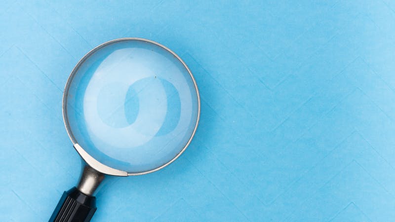 A magnifying glass over content representing search functionality