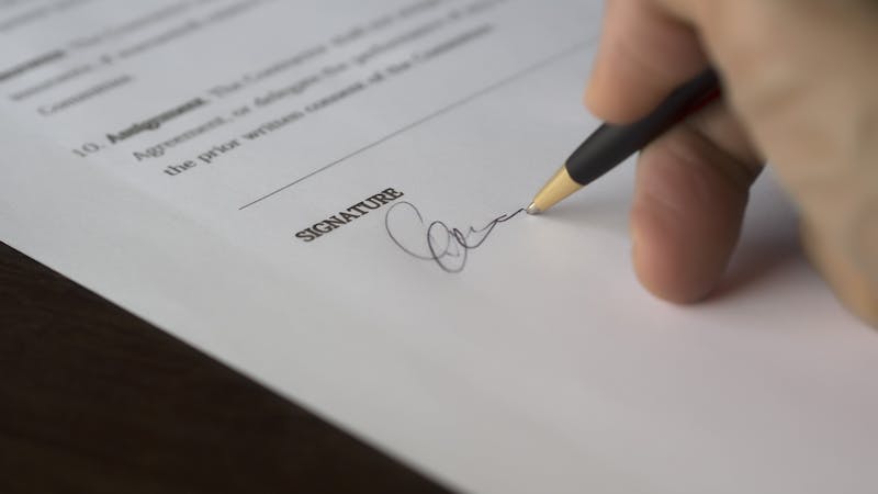 Two business partners signing a collaborative agreement