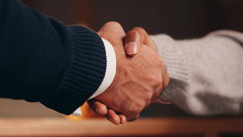 Business partners shaking hands to form an outsourcing partnership