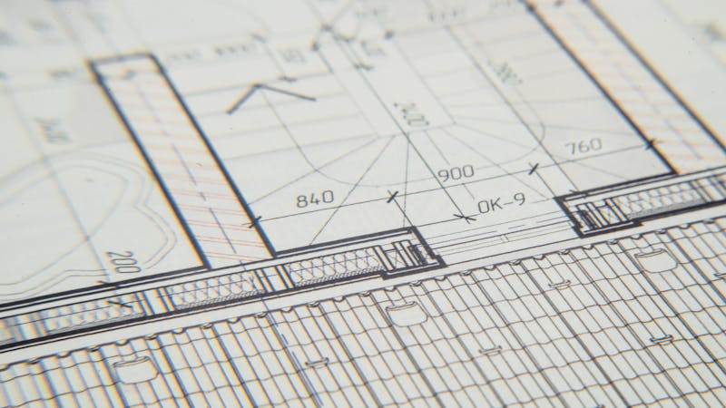 Technical specification document with notes and diagrams on a desk