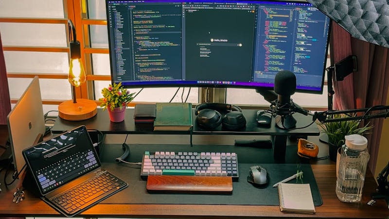 Developer workspace with multiple monitors and code editor open