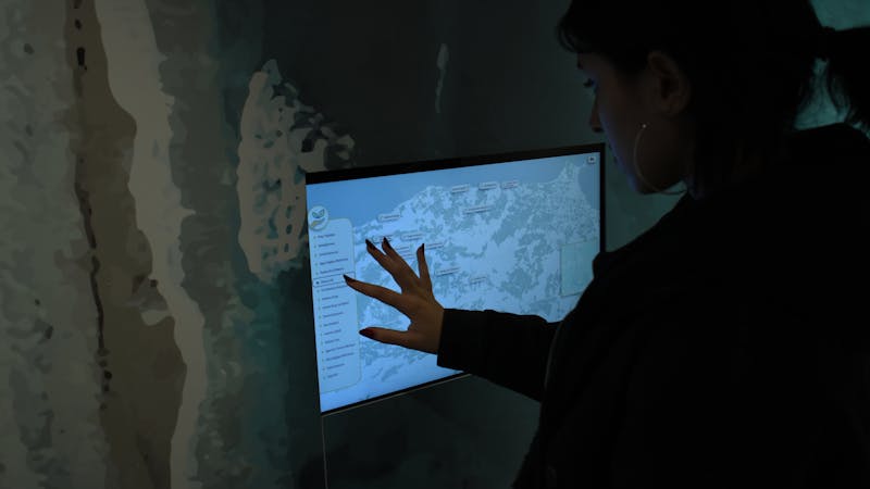 Finger tapping a touchscreen demonstrating direct interaction with a digital interface