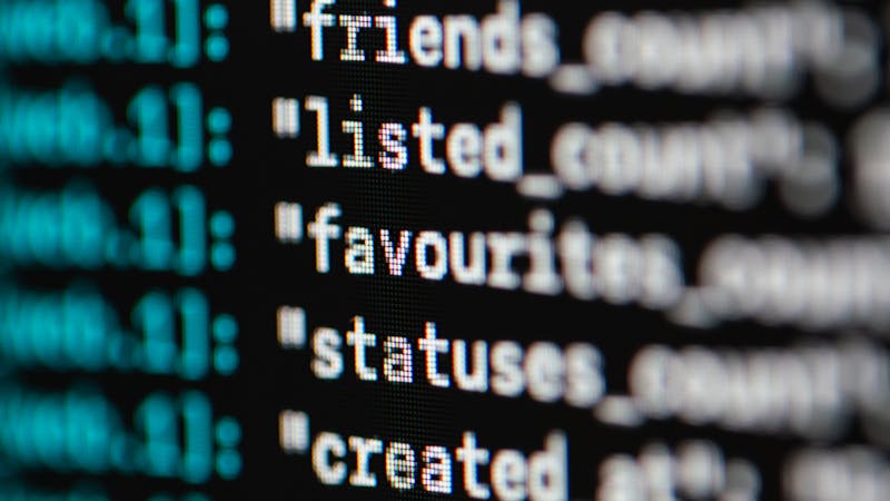 Developer writing SQL database queries on a computer screen