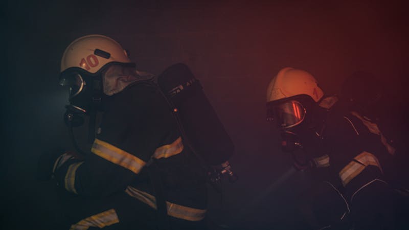 Team coordinating a crisis management response around a shared workspace