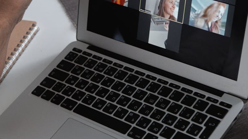 Team members collaborating on a video call with remote colleagues