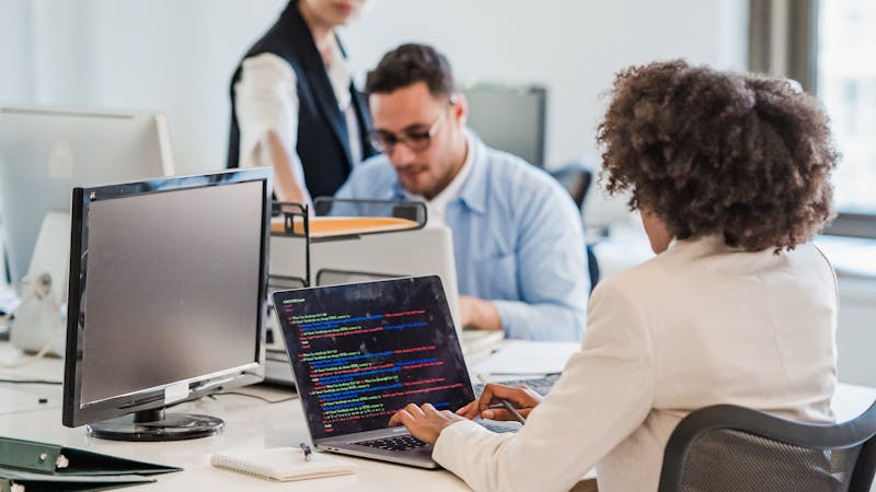 A startup team coding together in a focused collaborative workspace