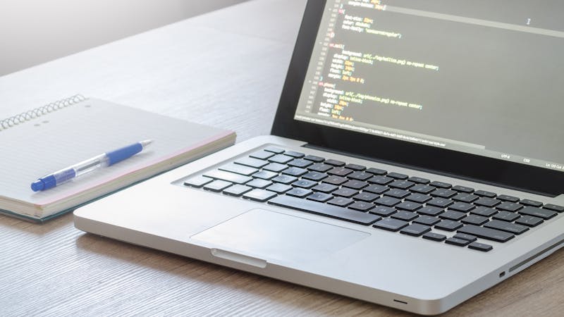 Developer workspace with code editor and programming tools on screen